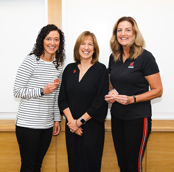 Sheri and Kendra receive dean's coins